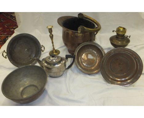 A large collection of metal wares to include oil lamp base, brass ornaments, candlesticks, trivets, wall mounted candle sconc