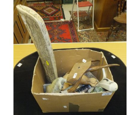 A box containing various carved items including antler figure decorated with seals and killer whale, carved wooden figure of 
