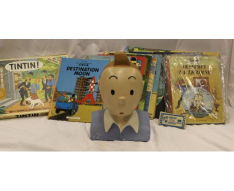 A collection of Tintin items including twenty vintage and modern books, board game and shop display head CONDITION REPORTS We