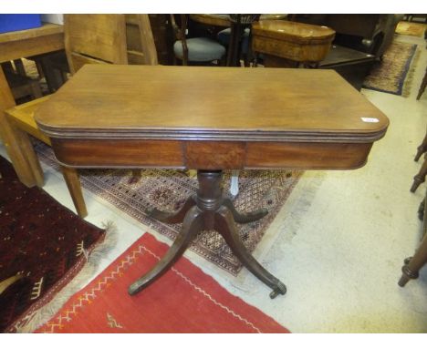 A Victorian mahogany fold-over card table raised on pedestal quadruped base to brass caps and castors