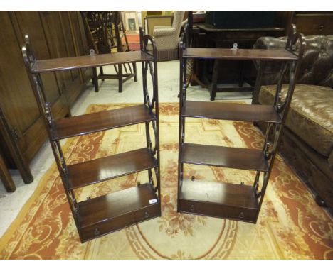 A pair of modern mahogany wall shelf units in the George III taste with open shelving above a single drawer