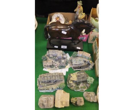 A collection of cottage ornaments to include Danbury Mint and David Winter, together with a patinated model of a horse raised