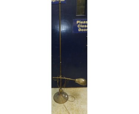 An early 20th Century style adjustable floor-standing brass reading lamp with shell shaped brassed shade