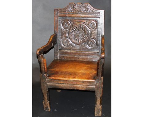 A 17th Century and later Wainscott type chair with carving to the back panel and all-over small carved monogrammed  "J" and l