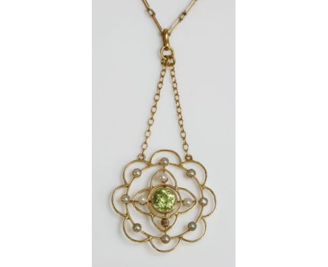 An Edwardian peridot and split pearl gold pendant, with a circular mixed cut peridot, milligrain set to a plain collet.  A tw