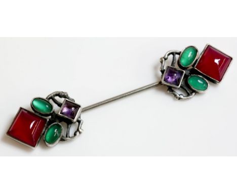 An Arts and Crafts silver amethyst and agate jabot, attributed to Sybil Dunlop.  A square cabochon amethyst rub set in a plai
