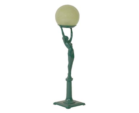 An Art Deco spelter table lamp,  cast as a nude female holding aloft a dish on which rests a mottled green glass globe,  87cm