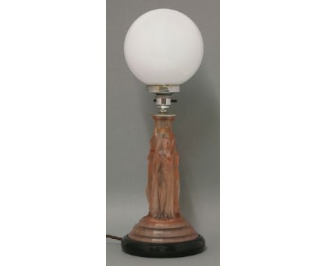 An Art Deco pink tinted glass table lamp, moulded with the Three Graces, on an ebonised base with a white globe, 45cm high