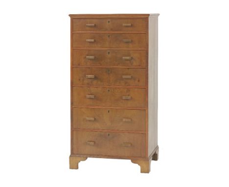 A walnut chest of seven graduated drawers, each drawer with a lock, raised on bracket feet, 63.5cm wide 47cm deep 122.5cm hig