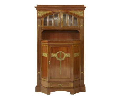 A Secessionist mahogany wall cabinet,  the moulded cornice over an arched and glazed cupboard, over a shelf, cupboard and dra