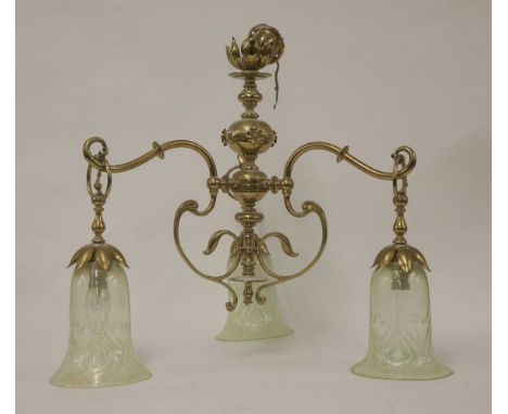 An Art Nouveau brass three-branch hanging light, with opaline bluebell-shaped shades, on scrolled branches and petal caps, 50