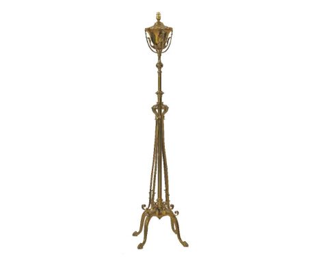 A Victorian brass telescopic standard lamp, with leaf applied cage on scrolled supports, converted to electricity, 154cm high