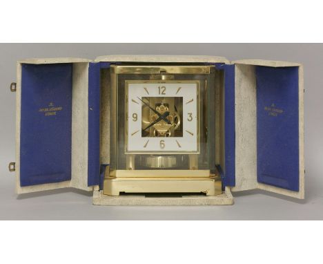 A Jaeger LeCoultre Atmos clock, in a brass case, with a square dial with white chapter ring,  23cm high, with original case 