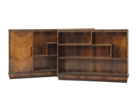 A pair of Art Deco bookcases, the first with a cupboard to the side, the other with shelves, both raised on a cushion plinth,