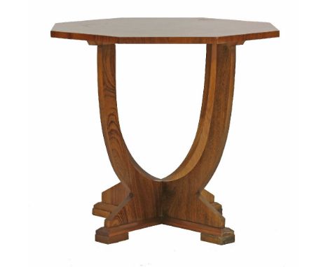 An octagonal walnut lamp table, the quarter veneered top raised on 'X' frame supports, on a chamfered stand and block feet, 6
