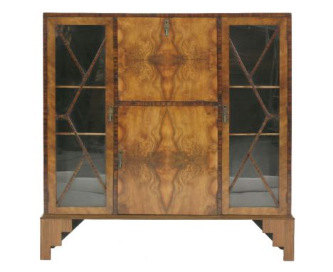 An Art Deco walnut and coromandel bureau display cabinet, the central hinged writing surface with pigeonholes and a pair of g