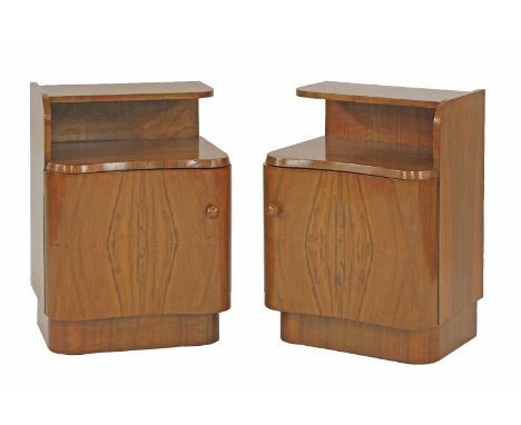 A pair of walnut kidney-fronted bedside cabinets, with a shelf over a cupboard, 43.5cm wide 34cm deep 62cm high (2)