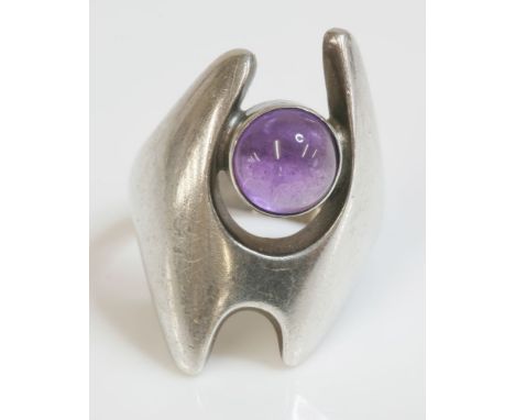 A sterling silver amethyst ring, by George Jensen No. 139, designed by Henning Koppel.  A circular cabochon amethyst, rub set