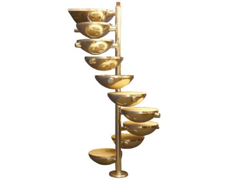 A polished steel spiral staircase or shelves,  each circular footplate of dished form, with nine steps, and a domed top brack