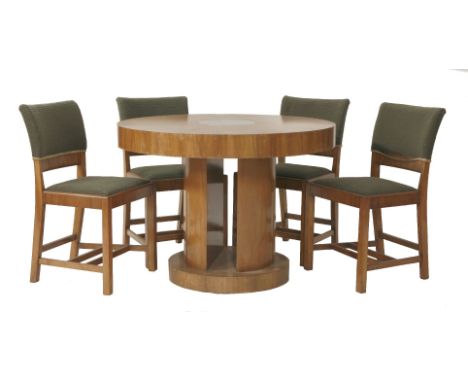 A set of four walnut dining chairs, with Heal's ivorine labels, together with a walnut circular dining table, the circular to