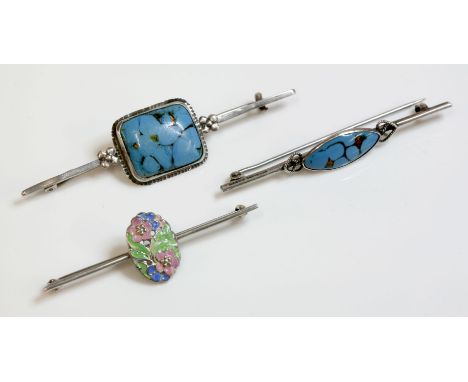 An Arts and Crafts silver bar brooch, attributed to Bernard Instone, with a marquise shaped opaque blue and bronze glass cabo