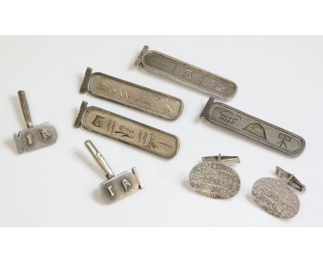 A pair of Egyptian silver swivel cufflinks, c.1970, composed of concave oval plates with raise hieroglyphic decoration to swi