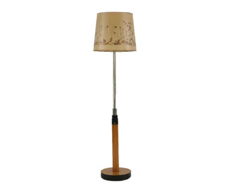 An Art Deco standard lamp, the multi-glass cluster column raised on a sycamore and ebonised base, with a pressed flower shade