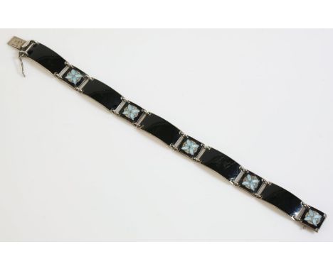 A Norwegian black enamel plaque bracelet, by Aksel Holmsen, with a series of curved rectangular plaques, decorated with a lig