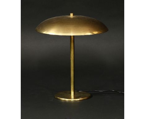 A brass desk lamp,  with a saucer shade and cream inside reflector, 31cm