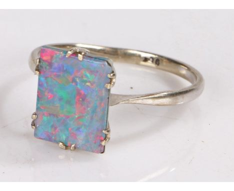 9 carat white gold and opal ring, the rectangular opal mounted in a basket form mount ring size Q