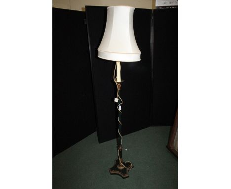 Standard lamp with candle effect stem above a column form central section and gadrooned foot