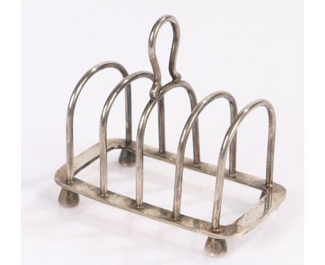 George V silver toast rack, Birmingham 1931, maker Mappin &amp; Webb, with loop finial above four divisions, on tapering feet