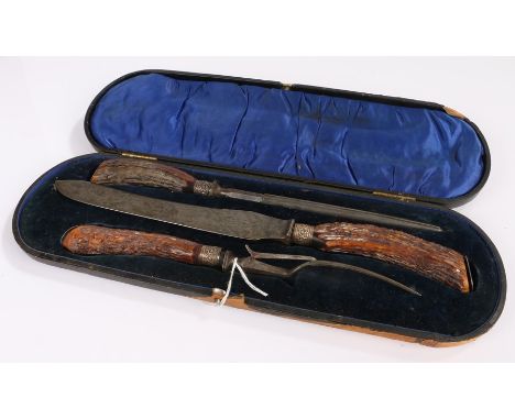 Antler handlesd carving set with silver collars, consisting of knife fork and steel, housed in a fitted leather case