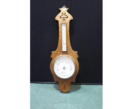 Art Nouveau style oak barometer/thermometer, with retailer name to dial W.S. Cowell Ltd. Ipswich,27.5cm wide by 83cm high