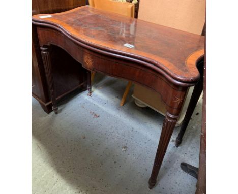 A 19th century mahogany and kingwood veneer card table of unusual sinuous form and serpentine front, standing on four taperin