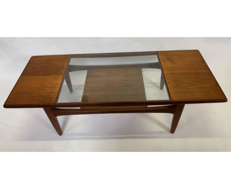 A rectangular G-Plan coffee table, with glass insert and lower shelf, 137cm long, 42.5cm high