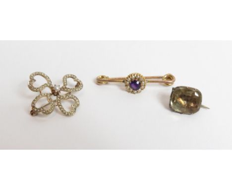 A gold Edwardian seed pearl brooch, unmarked, of four heart motifs enclosing a central small seed pearl; with an early Victor