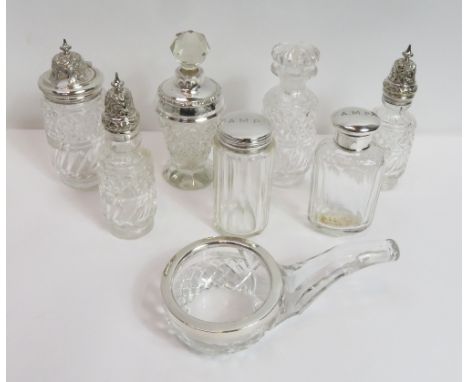 A silver mounted glass scent bottle, with glass stopper; two silver mounted glass toilet bottles; a glass bowl shaped like a 