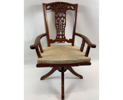 A modern Oriental hardwood desk swivel chair with decorative splat back, curved arms, solid seat with cushion and on four spl