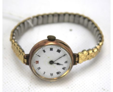 A vintage 9ct rose gold cased ladies wristwatch. The enamel dial with Roman numerals denoting hours, on expanding strap