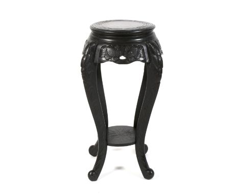 A late 19th century ebonised chinoiserie jardiniere stand. The circular top with carved floral apron, on four cabriole legs c