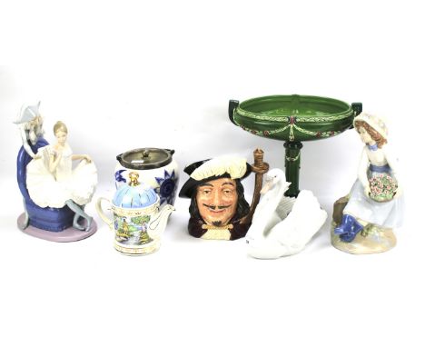 An assortment of ceramics. Including a Lladro swan, Nao figural groups, a Royal Doulton character jug, etc