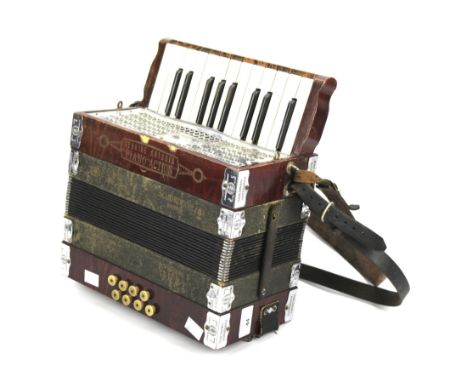 A Gebr Ludwig accordion. With piano action and leather straps