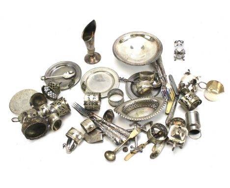 An assortment of silver plate. Including flatware, napkin rings, candle holder, etc