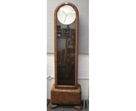 A mid-century Art Deco style burr walnut veneered longcase clock by Genfa. The silvered dial with Arabic numerals denoting ho