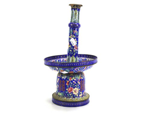 A Chinese enamel prick candlestick. With large drip pan, decorated throughout with traditional foliate and leaf motifs, on a 