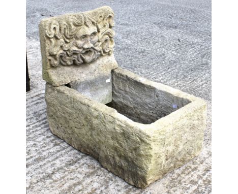 A 20th century composite stone planter trough and a water feature depicting the Green Man. Trough measuring L69cm, feature L4