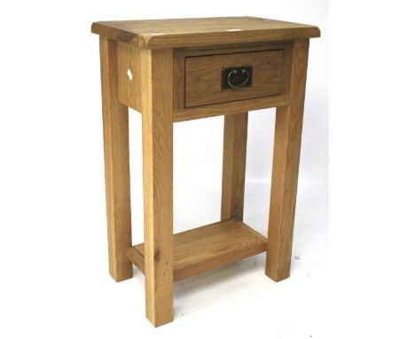 A contemporary oak bedside/side table. With a single drawer and lower shelf, L50cm x D32cm x H75cm