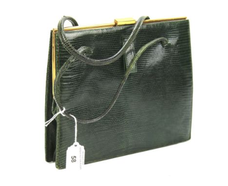 A vintage snakeskin vintage handbag. Green exterior with a brown suede interior lining