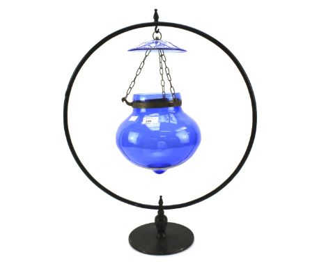 A blue glass hanging light. Supported by a metal frame of circular form, H67cm